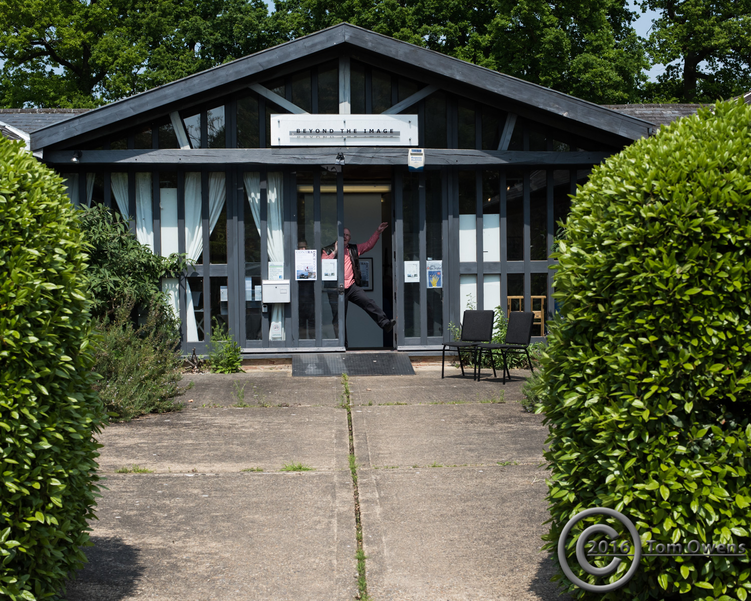 Man at door with arm and leg stuck out