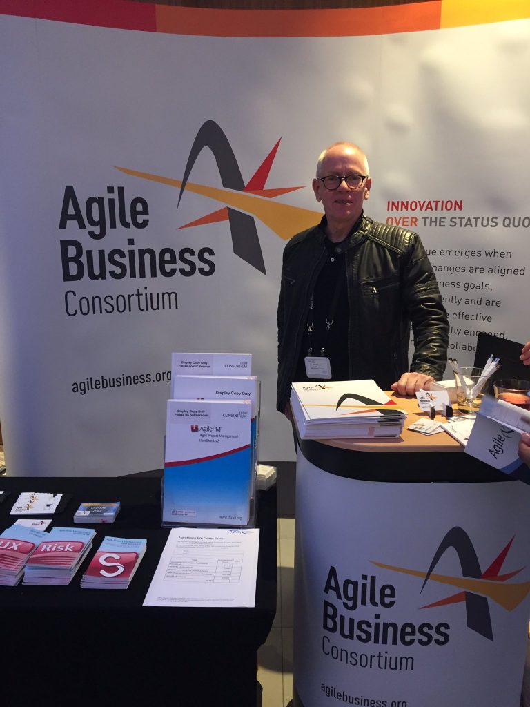 Man in biker kacket at agile Business Consortium stand